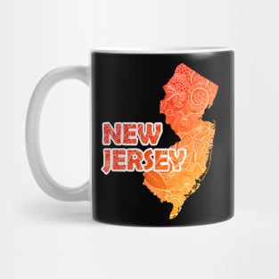 Colorful mandala art map of New Jersey with text in red and orange Mug